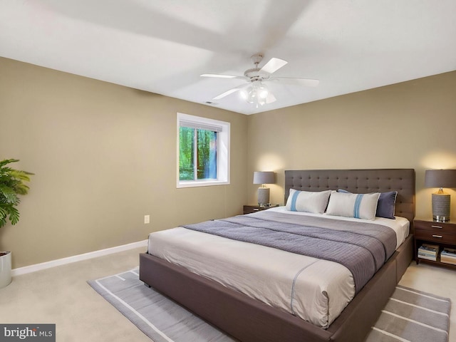 bedroom with carpet, baseboards, and a ceiling fan