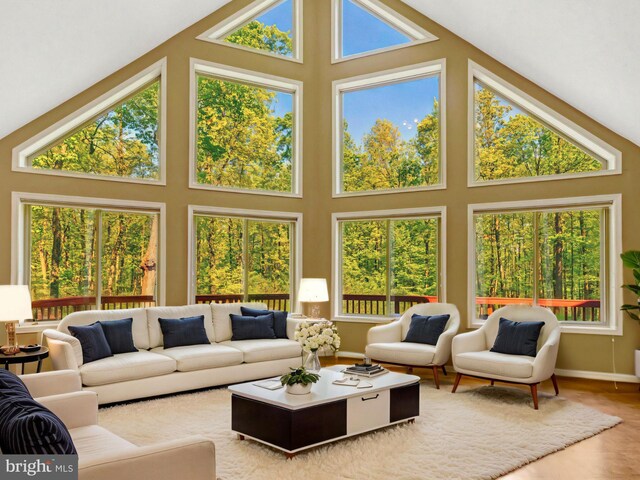 sunroom / solarium featuring lofted ceiling