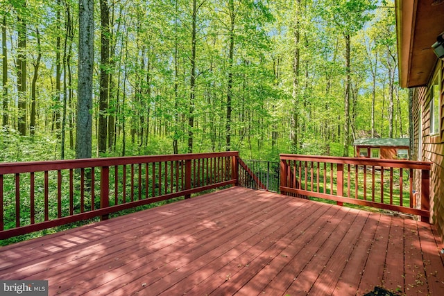 wooden terrace with a view of trees