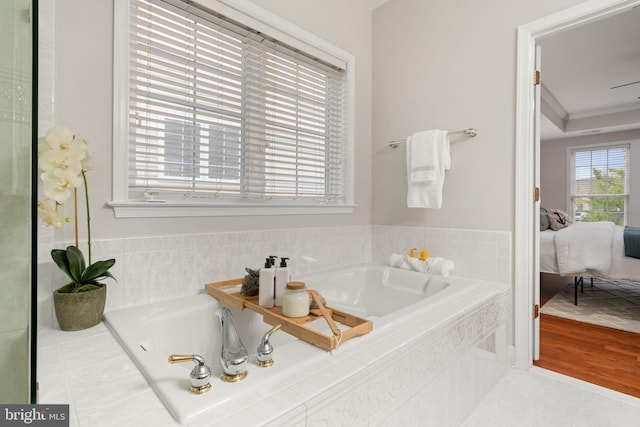 full bathroom featuring connected bathroom, a garden tub, and crown molding