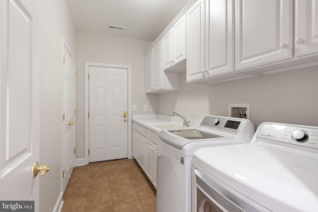 laundry area with a sink, visible vents, cabinet space, washer and dryer, and light tile patterned floors