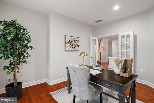 office featuring wood finished floors, visible vents, baseboards, and french doors