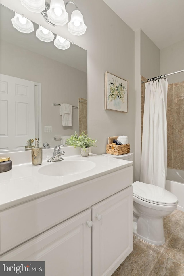 full bath with toilet, vanity, tile patterned floors, and shower / bath combo with shower curtain
