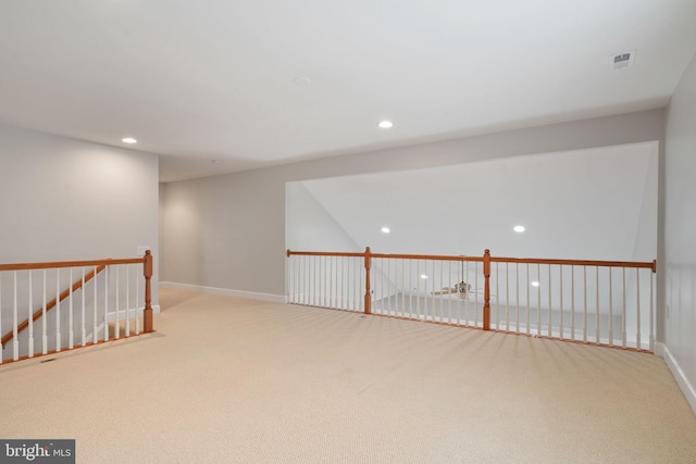 interior space featuring baseboards, carpet flooring, an upstairs landing, and recessed lighting