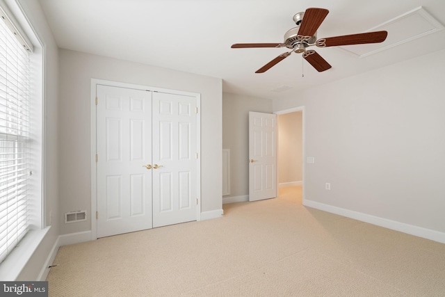 unfurnished bedroom with baseboards, carpet flooring, visible vents, and a closet