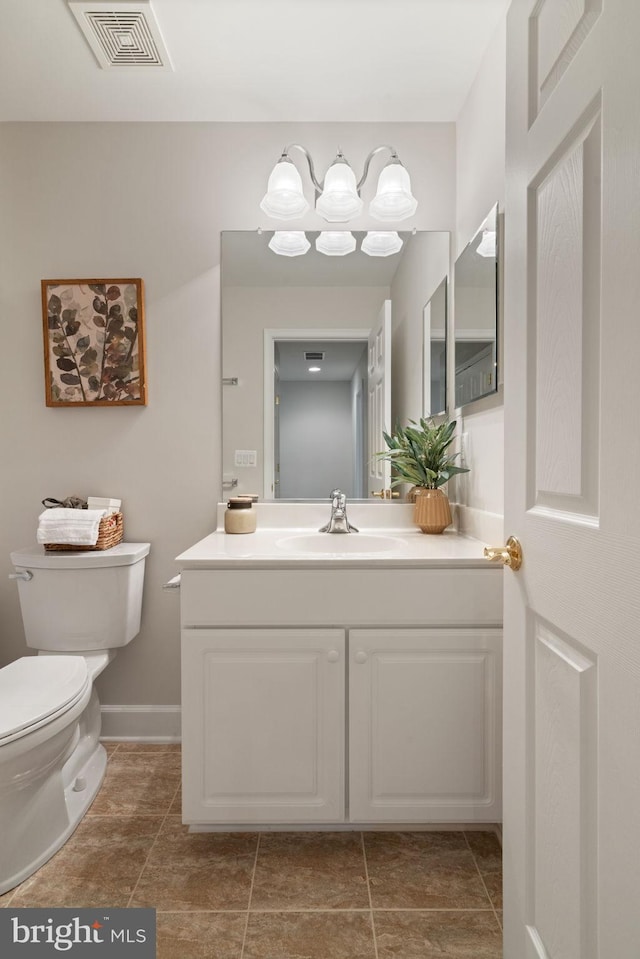 bathroom featuring tile patterned flooring, visible vents, toilet, and vanity