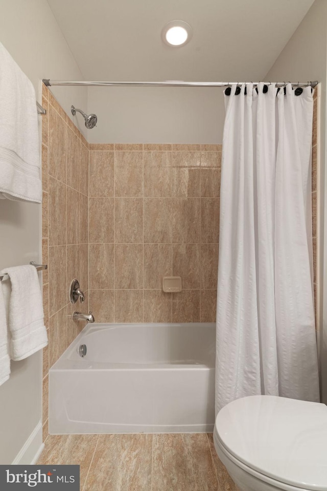 full bathroom featuring shower / tub combo and toilet