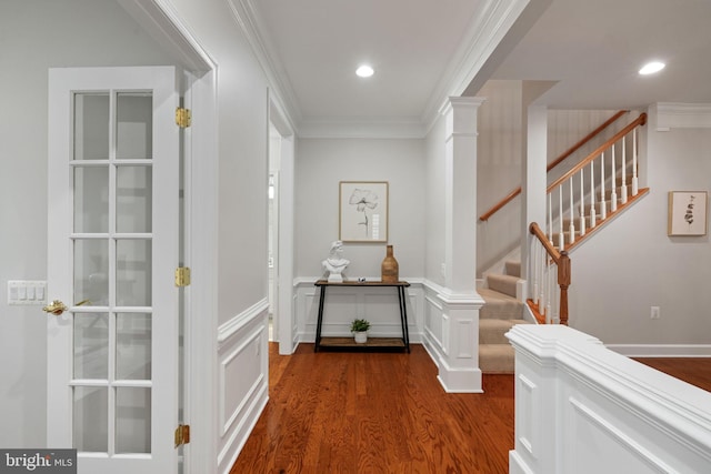 hall with stairway, wainscoting, dark wood finished floors, ornamental molding, and recessed lighting