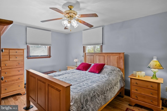 bedroom with a ceiling fan and light wood-style flooring