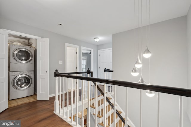 13126 Pelmira Ridge Ct, Herndon, VA 20171 - corridor with estacked washer and dryer, an upstairs landing, wood finished floors, and baseboards
