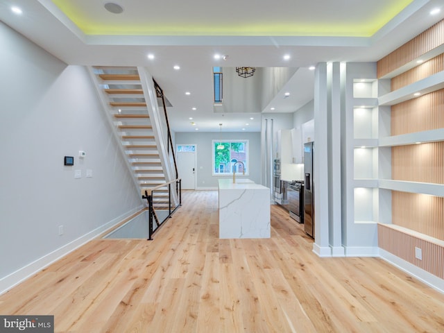 1021 E Palmer St, Philadelphia, PA 19125 - unfurnished living room featuring light wood-style floors, stairs, a sink, baseboards, and recessed lighting