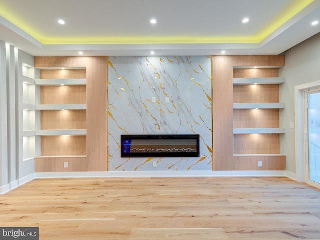1021 E Palmer St, Philadelphia, PA 19125 - unfurnished living room featuring built in shelves, a fireplace, wood finished floors, recessed lighting, and baseboards