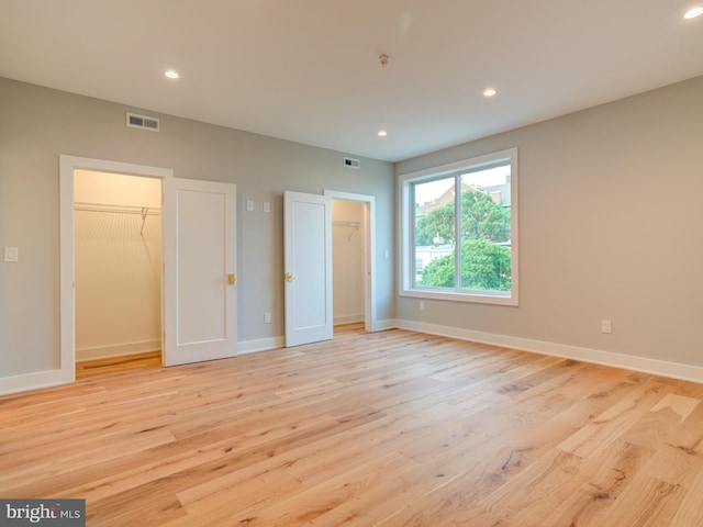 1021 E Palmer St, Philadelphia, PA 19125 - unfurnished bedroom with a walk in closet, light wood-type flooring, recessed lighting, and baseboards