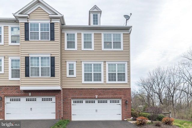 411 Cope Ct, Sellersville, PA 18960 - view of front of house featuring brick siding, aphalt driveway, and a garage