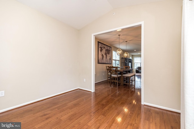 411 Cope Ct, Sellersville, PA 18960 - dining area with hardwood / wood-style flooring, baseboards, an inviting chandelier, and vaulted ceiling