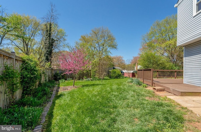 view of yard featuring a fenced backyard and a deck