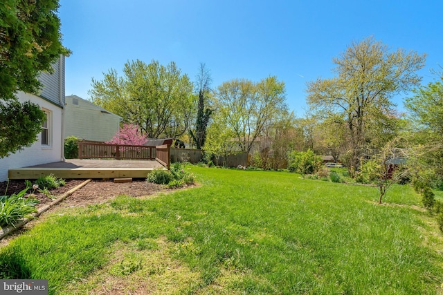 view of yard with fence and a deck