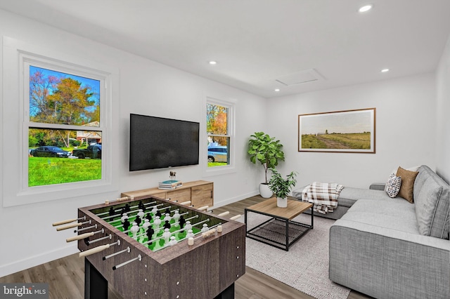 living area featuring a wealth of natural light, dark wood-style flooring, and recessed lighting