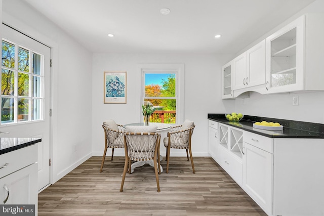 dining room with recessed lighting, light wood finished floors, and baseboards