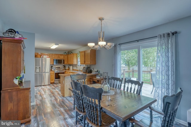 dining room with light wood-style floors and an inviting chandelier