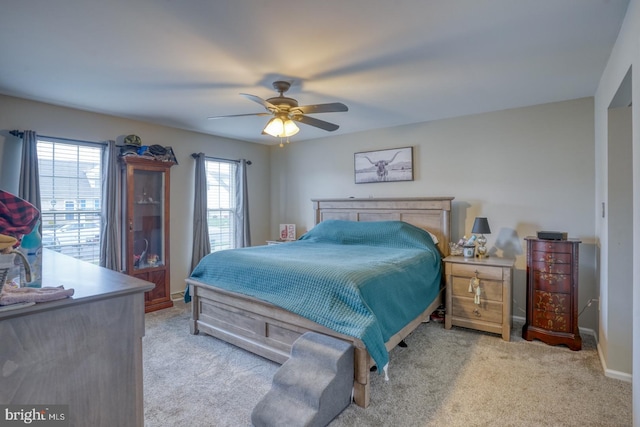 bedroom with baseboards, light colored carpet, and ceiling fan