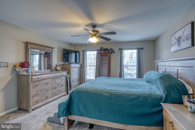 carpeted bedroom with baseboards and a ceiling fan
