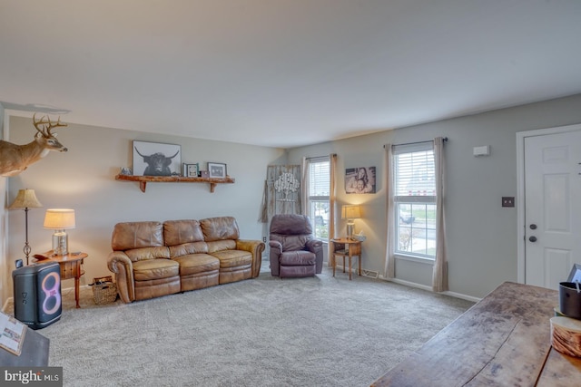 living area featuring baseboards and carpet