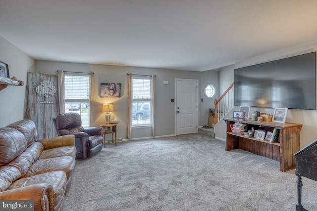 living room with baseboards, carpet flooring, and stairway