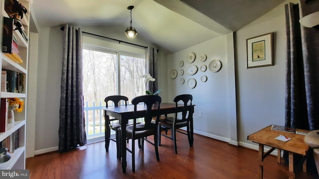 dining space featuring baseboards, vaulted ceiling, and dark wood-style floors