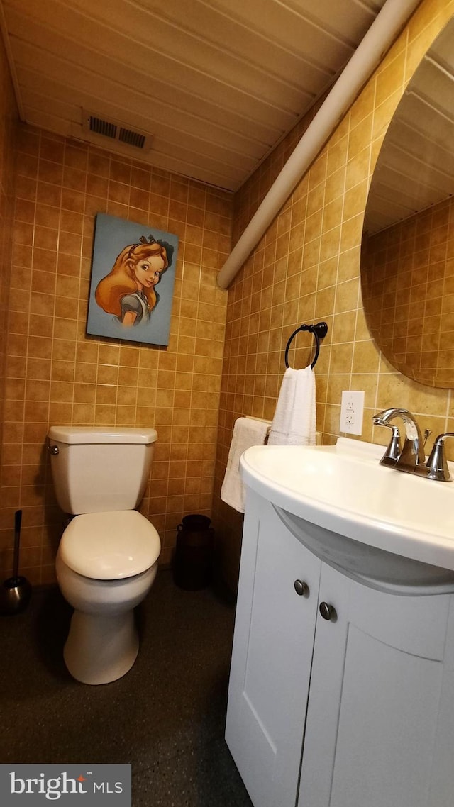 half bath with decorative backsplash, vanity, tile walls, wood ceiling, and toilet