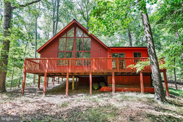 rear view of house featuring a wooden deck and a carport