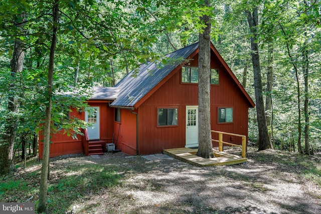 exterior space featuring roof with shingles and entry steps