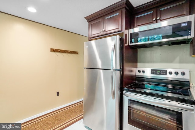 kitchen featuring stainless steel appliances, dark brown cabinets, recessed lighting, and baseboards