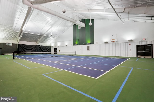 view of tennis court with community basketball court and fence