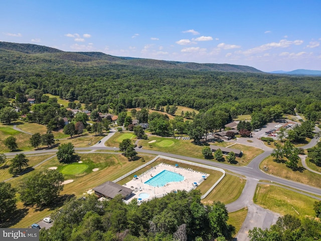 drone / aerial view featuring a wooded view and a mountain view
