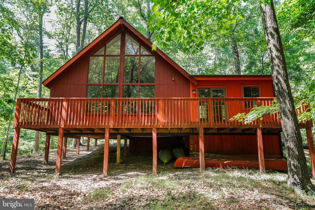rear view of house featuring a deck and a carport