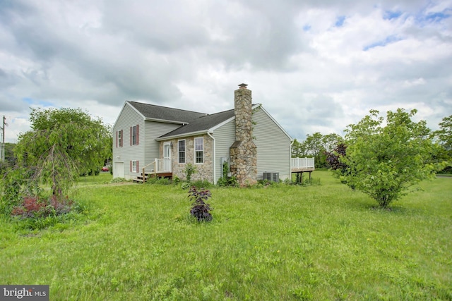 view of home's exterior featuring a chimney, cooling unit, stone siding, and roof with shingles