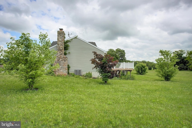 view of yard featuring a deck and cooling unit