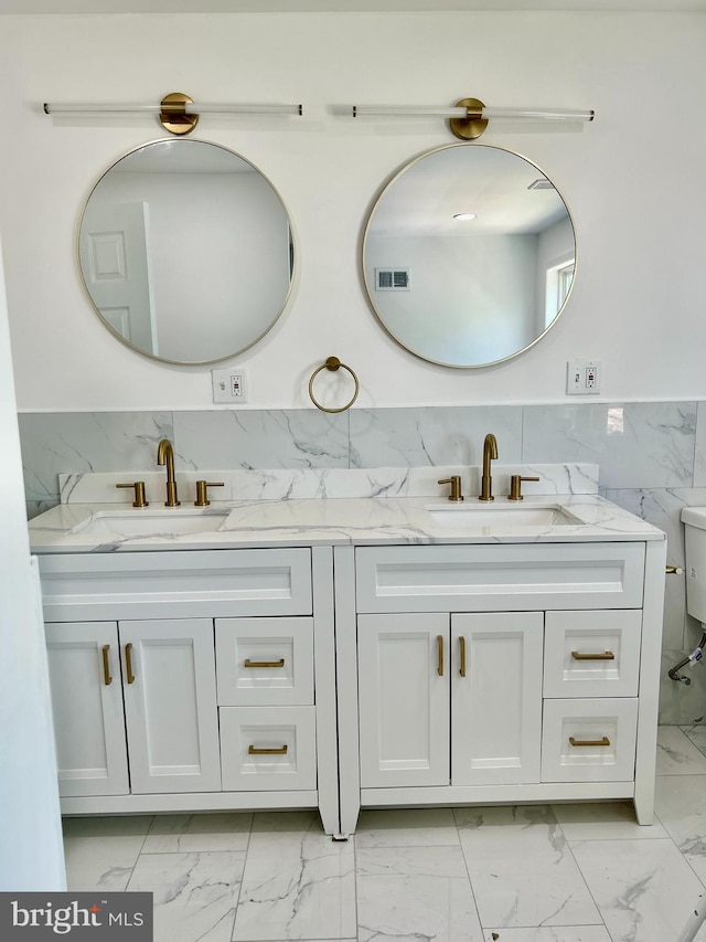 580 Bath St, Bristol, PA 19007 - full bath featuring marble finish flooring, tile walls, double vanity, and toilet