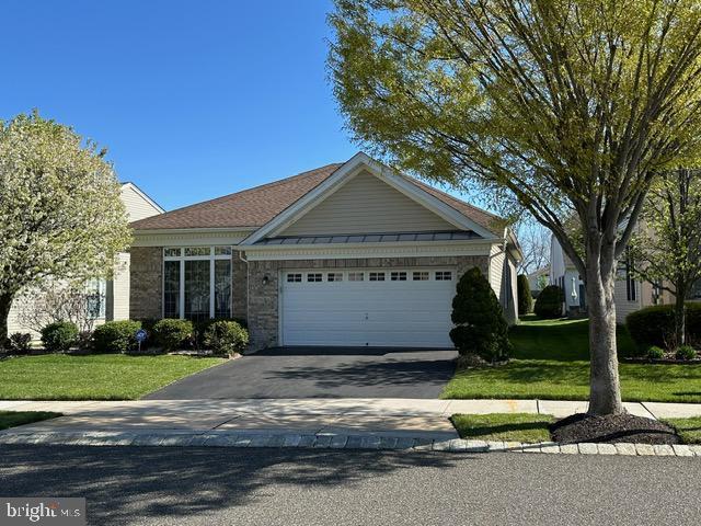 35 Galileo Dr, Cranbury, NJ 08512 - ranch-style house featuring brick siding, an attached garage, a front lawn, and driveway