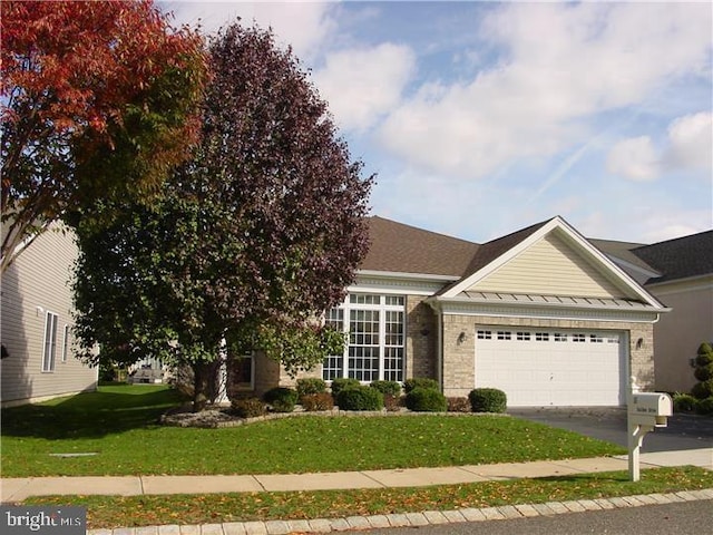 35 Galileo Dr, Cranbury, NJ 08512 - obstructed view of property with driveway, an attached garage, a front yard, brick siding, and a standing seam roof