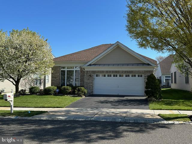 35 Galileo Dr, Cranbury, NJ 08512 - view of front of property with a garage, driveway, stone siding, and a front lawn