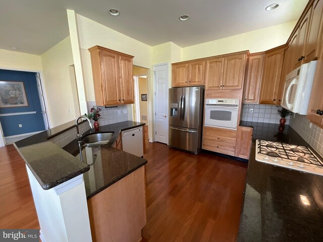 35 Galileo Dr, Cranbury, NJ 08512 - kitchen with dark wood finished floors, dark stone countertops, a sink, and white appliances