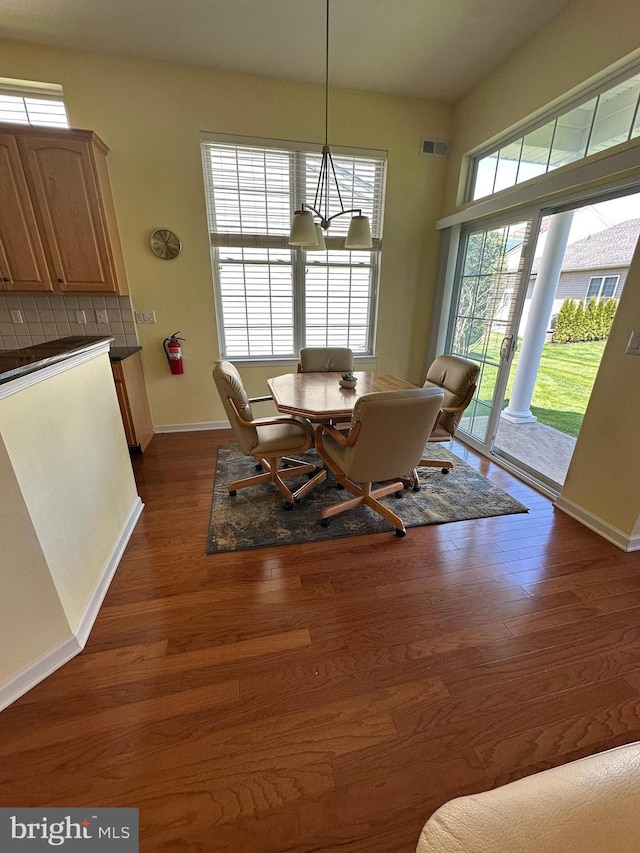 35 Galileo Dr, Cranbury, NJ 08512 - dining area featuring dark wood-type flooring, visible vents, baseboards, and an inviting chandelier
