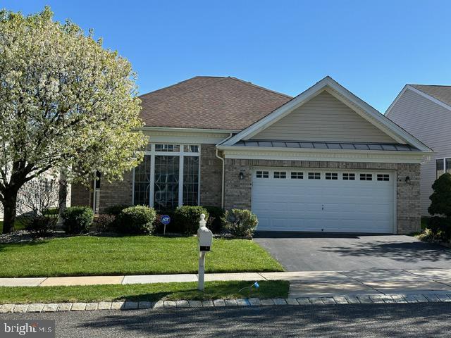 35 Galileo Dr, Cranbury, NJ 08512 - view of front facade featuring brick siding, an attached garage, and driveway