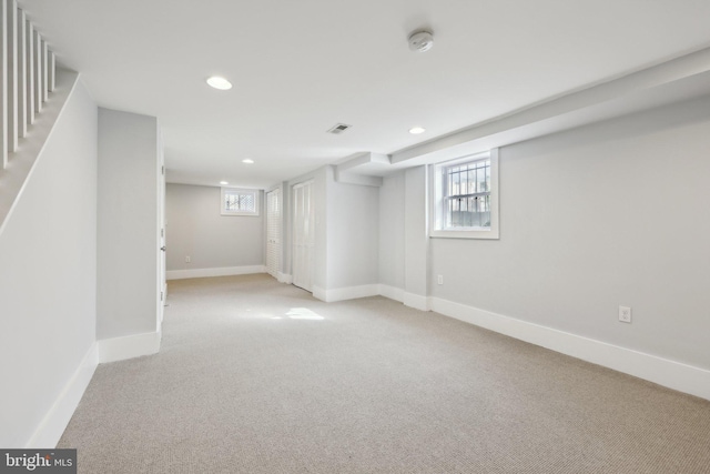 2026 Savannah Pl SE, Washington, DC 20020 - below grade area featuring light carpet, a wealth of natural light, baseboards, visible vents, and recessed lighting