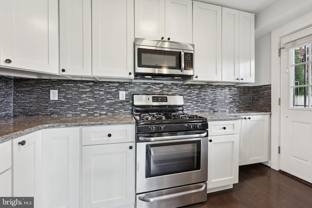 2026 Savannah Pl SE, Washington, DC 20020 - kitchen featuring light stone counters, decorative backsplash, white cabinets, appliances with stainless steel finishes, and dark wood-type flooring