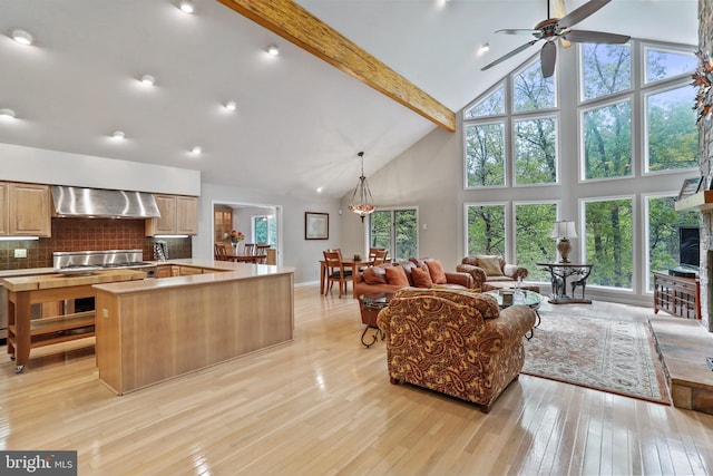 living area featuring ceiling fan, light wood-style floors, baseboards, beam ceiling, and high vaulted ceiling