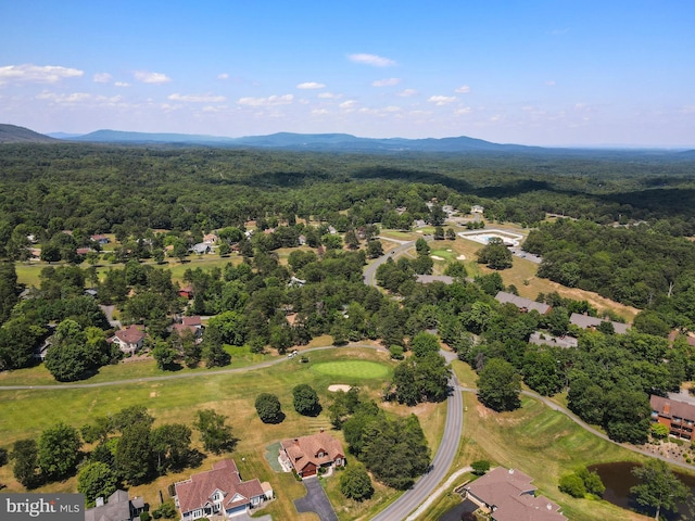 aerial view with a wooded view and a mountain view