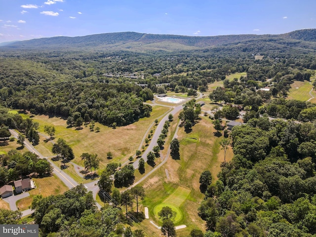 birds eye view of property featuring a wooded view and a mountain view